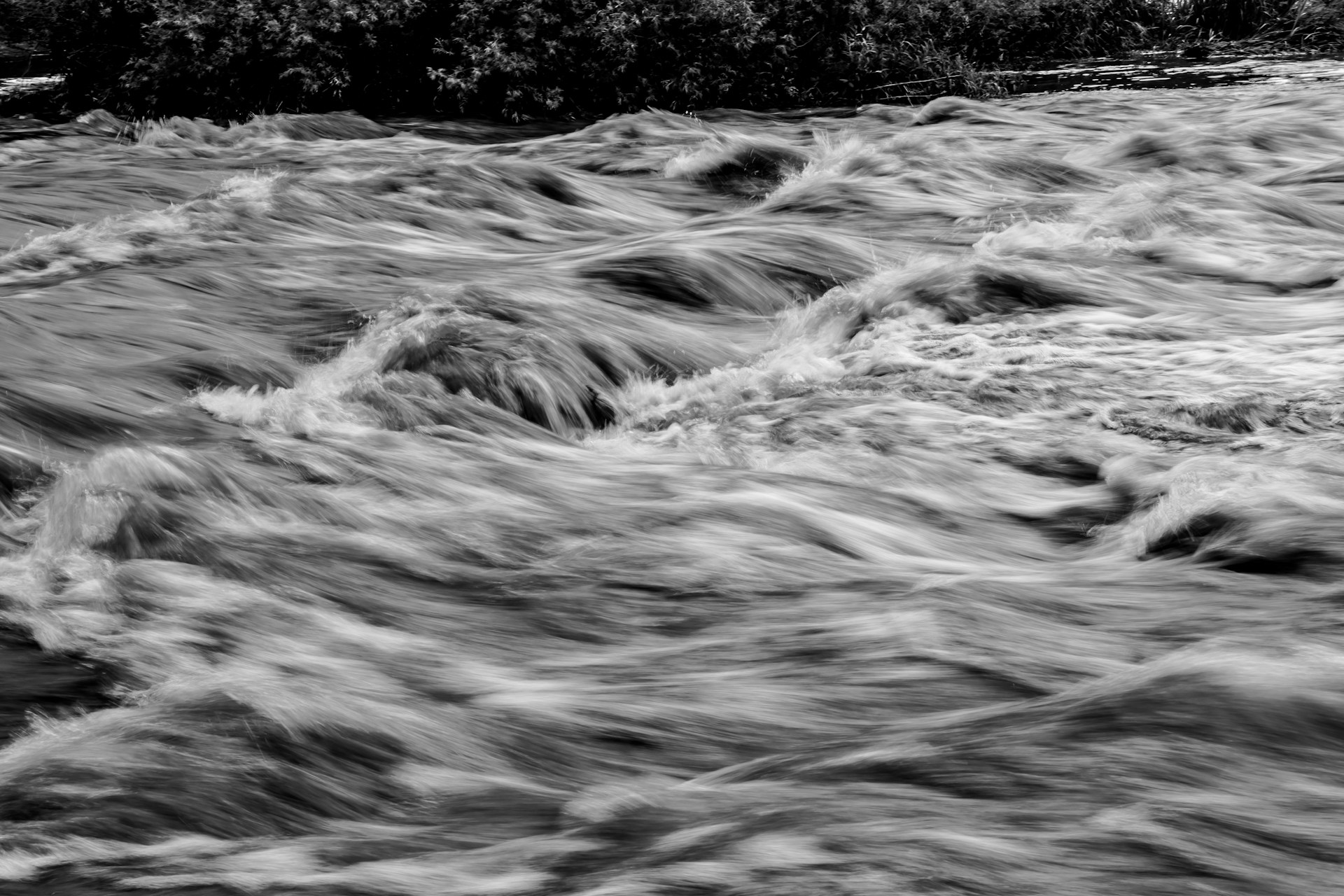 Grayscale image of rushing waves